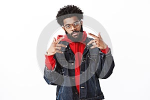 Celebrity posing paparazzi. Self-satisfied cool and arrogant african american bearded male rapper with afro hairstyle