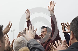 Celebrity Raising Hands For Crowd