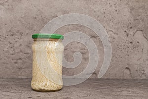 Celery Root Salad Preserve In Glass Jar With Screw Metal Cap On Shelf. Shredded And