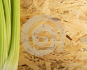 Celery stalks on wood background