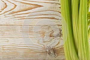 Celery stalks on wood background