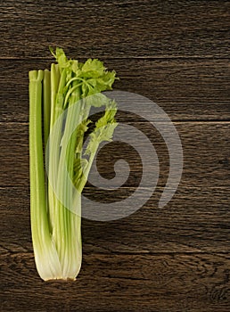 Celery stalks on wood background