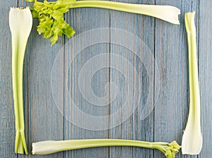 Celery stalks on wood background