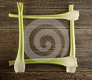 Celery stalks on wood background