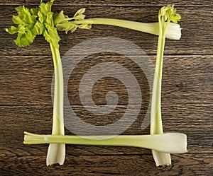 Celery stalks on wood background