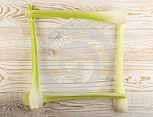 Celery stalks on wood background