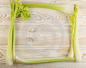 Celery stalks on wood background