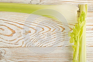 Celery stalks on wood background