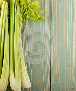 Celery stalks on wood background