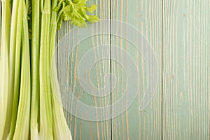 Celery stalks on wood background