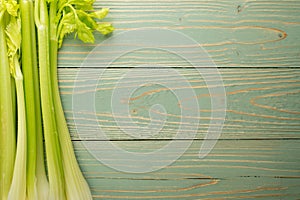 Celery stalks on wood background