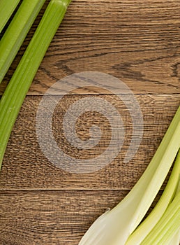 Celery stalks on wood background