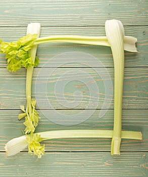 Celery stalks on wood background