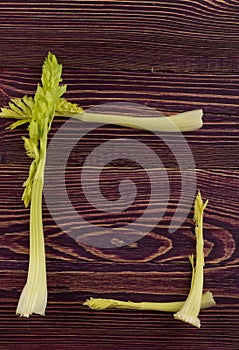 Celery stalks on wood background