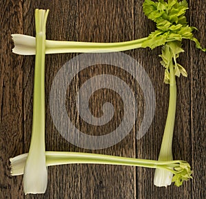 Celery stalks on wood background