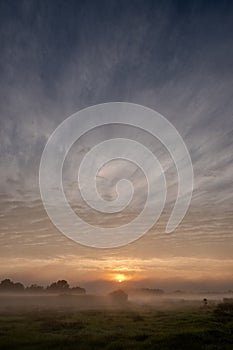 Celestial Dawn Over Mist-Covered Meadows