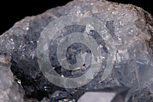 Celestine mineral stone macro on microcline on black background