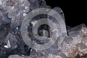 Celestine mineral stone macro on microcline on black background