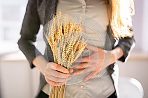 Celiac Disease And Gluten Intolerance. Women Holding Spikelet photo