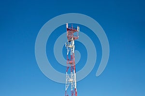 Cell phone antenna, transmitter. Telecom radio mobile antenna against blue sky