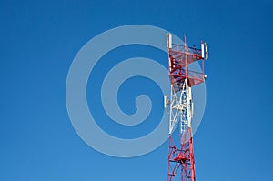 Cell phone antenna, transmitter. Telecom radio mobile antenna against blue sky