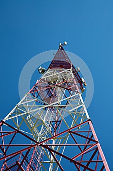 Cell phone antenna, transmitter. Telecom radio mobile antenna against blue sky