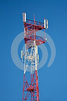 Cell phone antenna, transmitter. Telecom radio mobile antenna against blue sky