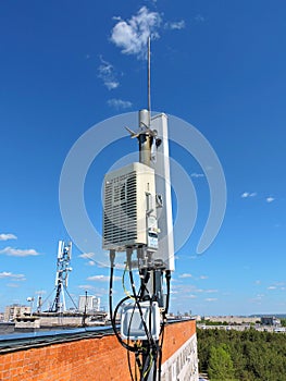 Cell phone antenna, transmitter. Telecom radio mobile antenna against blue sky