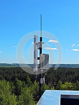 Cell phone antenna, transmitter. Telecom radio mobile antenna against blue sky