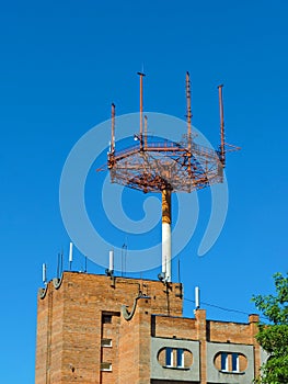 Cell phone antenna, transmitter. Telecom radio mobile antenna against blue sky