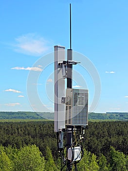 Cell phone antenna, transmitter. Telecom radio mobile antenna against blue sky