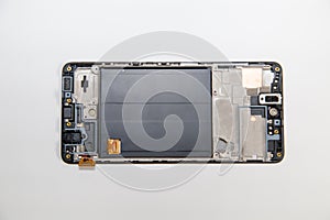 Cell phone without back cover isolated on a white background, repair equipment telephony