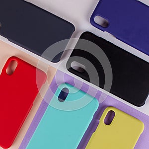 Cell phone cases various colors on multicolor paper background