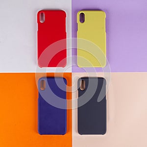 Cell phone cases various colors on multicolor paper background