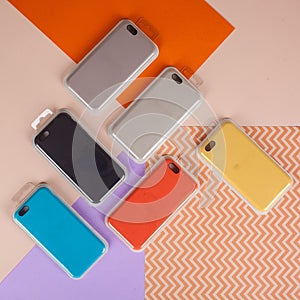 Cell phone cases various colors on multicolor paper background