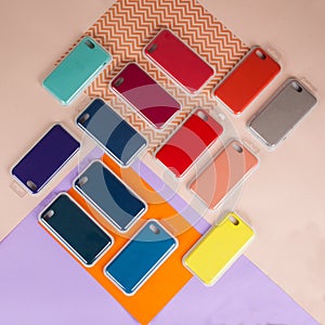 Cell phone cases various colors on multicolor paper background