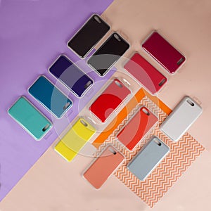 Cell phone cases various colors on multicolor paper background