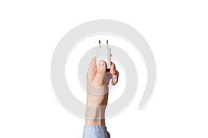 Cell phone charger in a man`s hand. On a white background. .Charger for mobile phone in hand on white background isolation