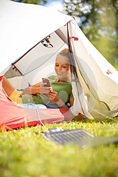 Cell phone charging with a solar charger in a tent during  trip