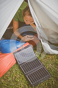 Cell phone charging with a solar charger in a tent during  trip