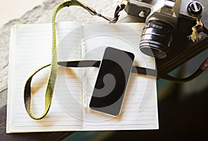 Cell phone, diary and old photo camera