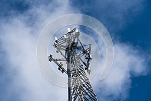 Cell phone or mobile service tower providing broadband internet service against blue sky