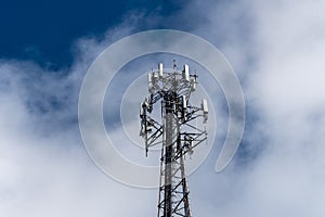 Cell phone or mobile service tower providing broadband internet service against blue sky