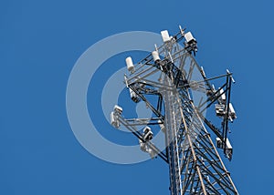 Cell phone or mobile service tower providing broadband internet service against blue sky photo