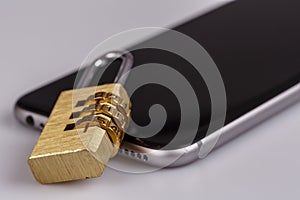 Cell phone security - lock and phone on white