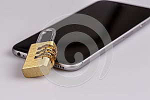 Cell phone security - lock and phone on white