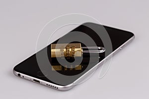 Cell phone security - lock and phone on white