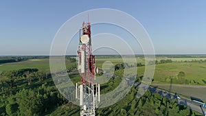 Cell phone telecommunication tower, drone view of worker servicing antenna