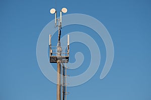 A cell phone tower in the blue sky