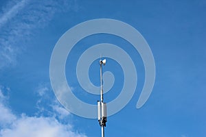 A cell phone tower on blue sky background